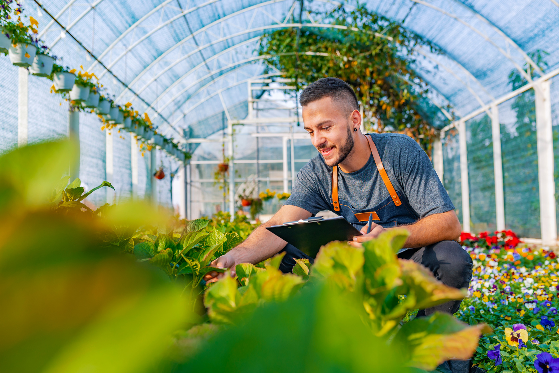 Portrait of a smiling greenhouse worker.